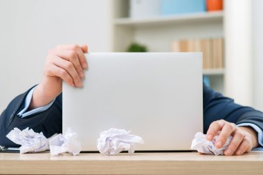 Nice worker playing with paper at the table