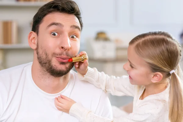 Vivacious father and daughter laying together — Stock Photo, Image