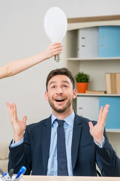 Overjoyed office worker sitting at the table — 스톡 사진