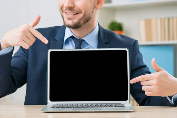 Diligent office worker pointing out his laptop — Stock Photo, Image