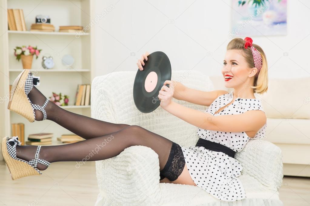 Young appealing woman with vinyl record.