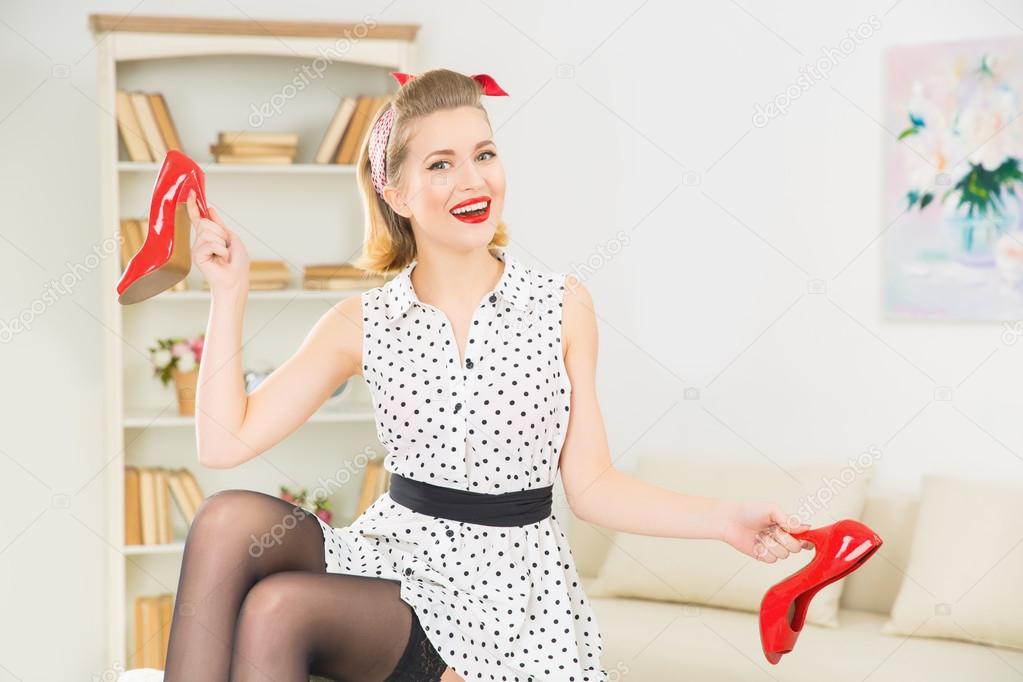 Young attractive woman playing with her shoes.