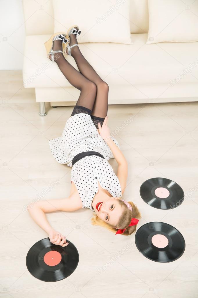 Young attractive girl among vinyl recordings.