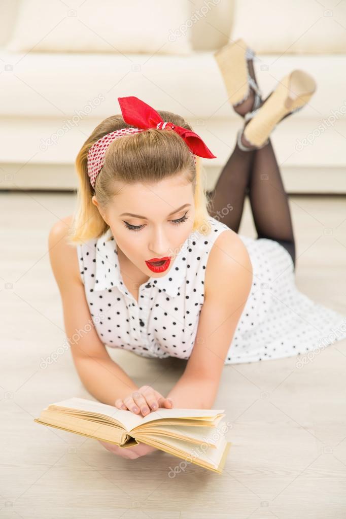 Young attractive woman is reading a book.