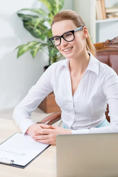 Pleasant office worker sitting at the table — Stock Photo, Image