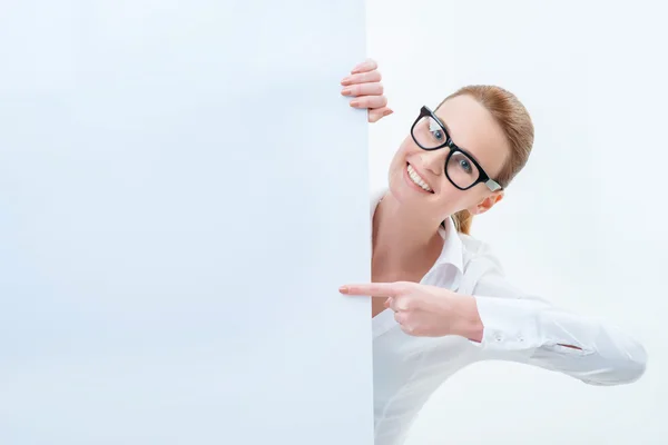 Vivacious woman looking out of white board — Stock Photo, Image