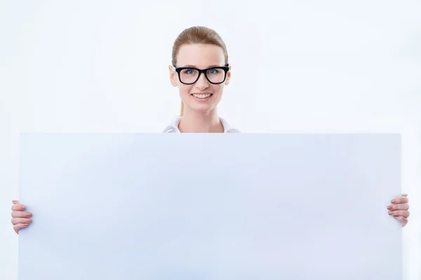 Cheerful woman holding white board — Stock Photo, Image