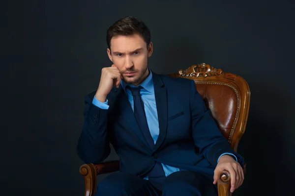 Confident businessman sitting in armchair — Stock Photo, Image