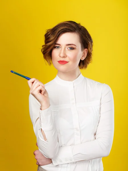 Jovem mulher bonita segurando uma caneta — Fotografia de Stock