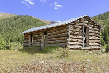 Vintage Log cabin in old abandoned mining town clipart