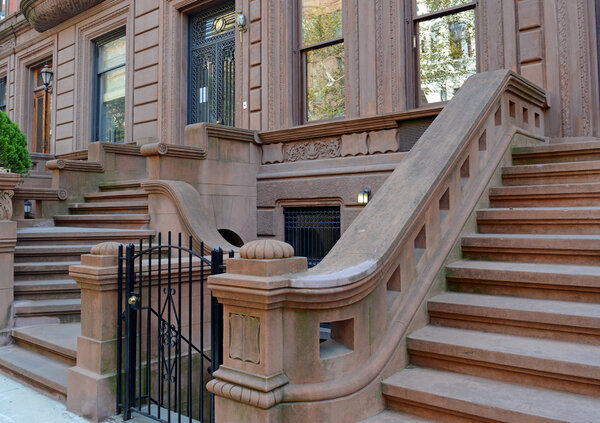 Brownstone apartment building with staircase in New