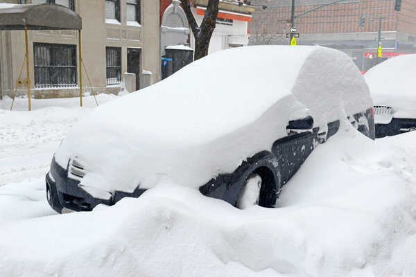 Snow covered car on city street in Manhattan New York