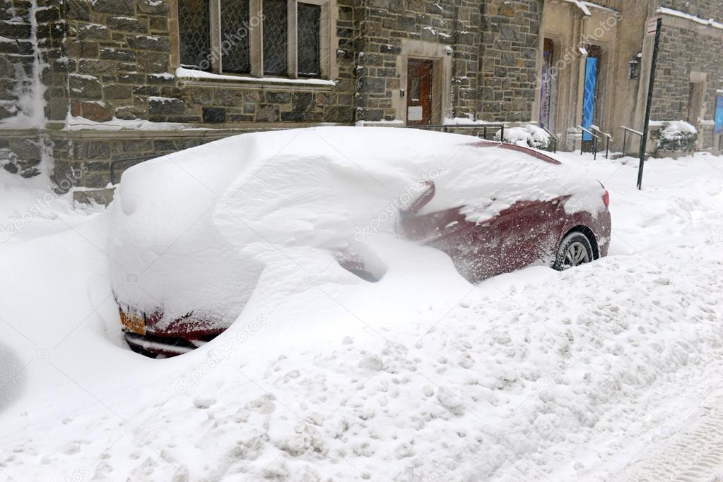 Snow covered car on city street in Manhattan New York