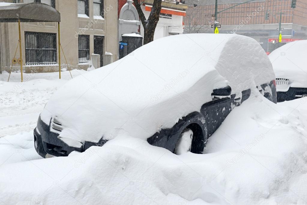 Snow covered car on city street in Manhattan New York