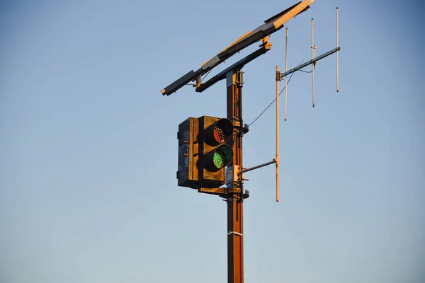 Railway traffic light. data transmission antenna. sky on blue background. transport infrastructure. trains and railways. railway equipment.