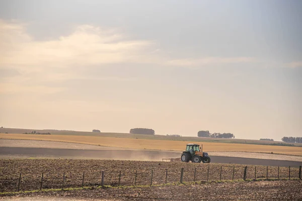 Agricultural tractor. Planting and land preparation. Grain sowing. Agriculture. rural landscape. Pampa biome fields in Brazil. Soy planting. No-till technique. Soil turning.