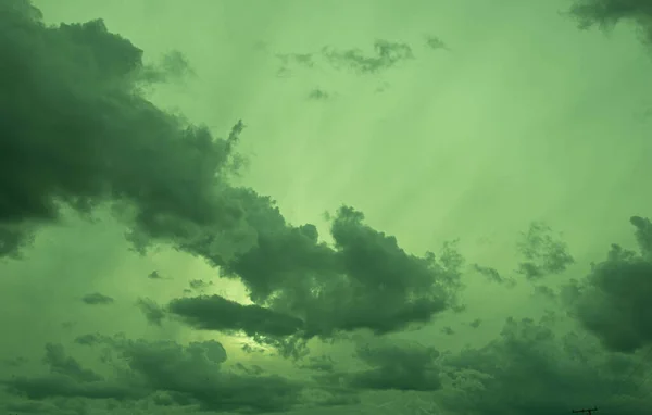 Colorful rain clouds at dusk. Rain-forming clouds. Sunset in the skies of Latin America. Phenomena of nature. Natural watercolors of weather phenomena.