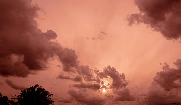 Colorful rain clouds at dusk. Rain-forming clouds. Sunset in the skies of Latin America. Phenomena of nature. Natural watercolors of weather phenomena.