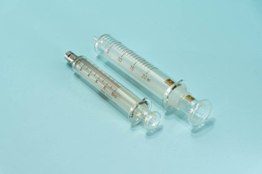 Glass serects for medical use on blue background. Medical equipment. Hospital supplies. Material used for the preparation and administration of a medicine.