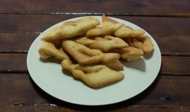 Fried wheat dumplings known as chiacchiere or cat's ear. Gluten-based food. Italian dumplings also called Crostoli, cavaquinho, ceroula turned in Brazil or coscoro in Portugal