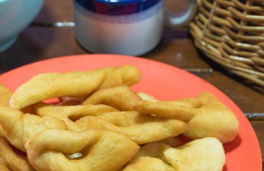 Fried wheat dumplings known as chiacchiere or cat's ear. Gluten-based food. Italian dumplings also called Crostoli, cavaquinho, ceroula turned in Brazil or coscoro in Portugal