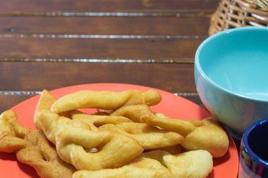 Fried wheat dumplings known as chiacchiere or cat's ear. Gluten-based food. Italian dumplings also called Crostoli, cavaquinho, ceroula turned in Brazil or coscoro in Portugal