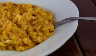 Beyaz tabakta servis edilen ev yapımı tavuklu risotto. Porselende servis edilen İtalyan pirinci. Tipik Brezilya mutfağı yemeği. Mutfak lezzeti. Ev yapımı ve geleneksel yemekler..