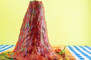 Volcanic clay model school projects. Children's school work. Volcano made with clay in a craft class. clipart