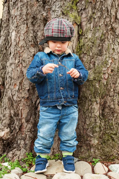 Outdoor portrait of a toddler boy, wearing denim clothes — Stock Photo, Image