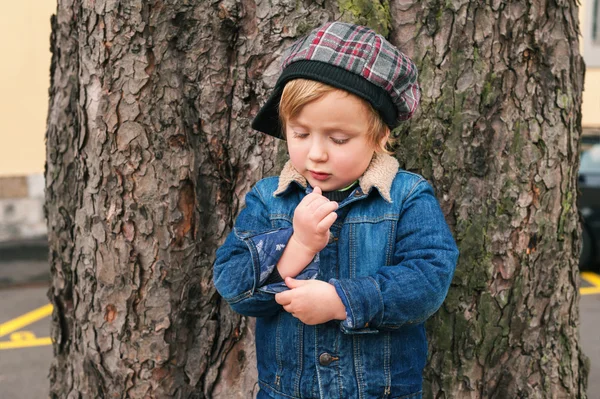 Outdoor portrait of a toddler boy, wearing denim clothes — Stock Photo, Image