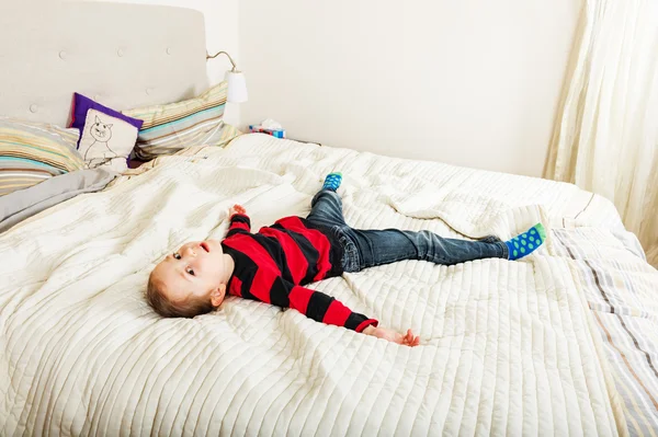 Tired toddler girl resting on the bed — Stock Photo, Image