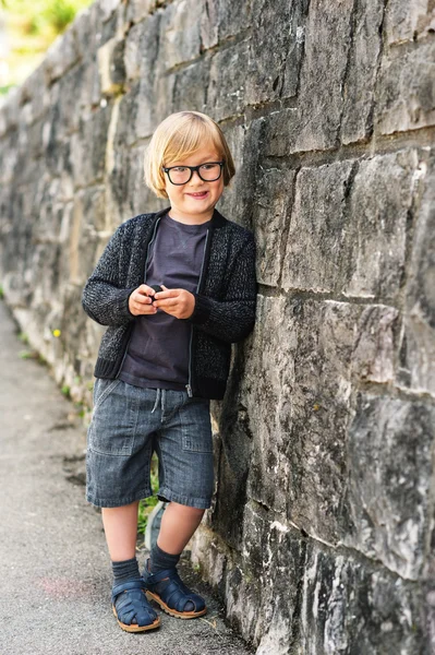 Outdoor portrait of a cute little boy in glasses — Stock Photo, Image
