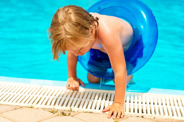 Happy little boy playing in swimming pool on a hot summer day — Stock Photo, Image