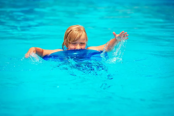 Happy little boy playing in swimming pool on a hot summer day — Stock Photo, Image