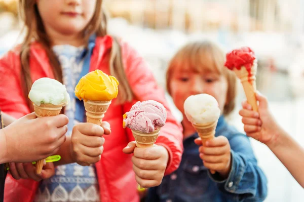 5 corns of colorful ice cream holding by kids — Stock Photo, Image