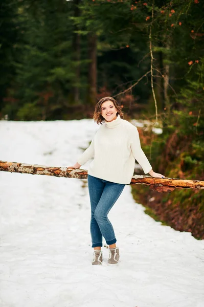 Early spring portrait of young happy woman enjoying nice day in forest