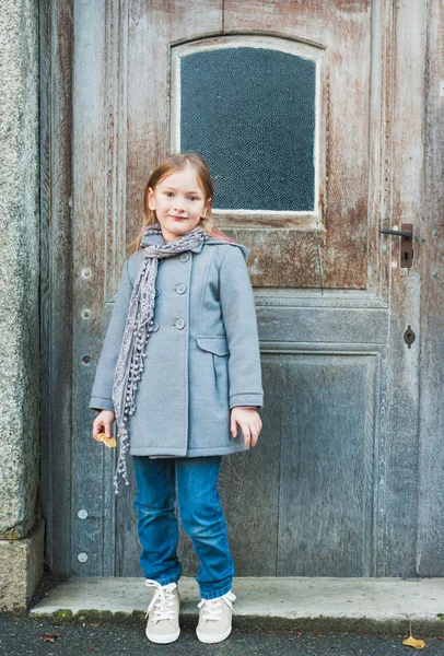 Retrato ao ar livre de uma menina bonita em um casaco cinza — Fotografia de Stock