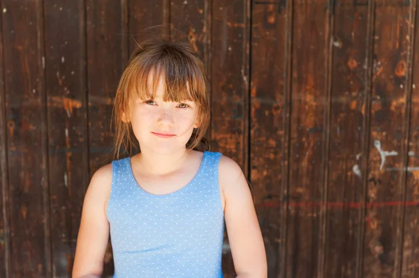 Cute little girl hiding from the heat in a shadow — Stock Photo, Image