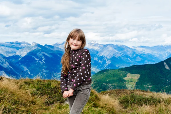 Portrait of little girl with mountains on background — Stock Photo, Image