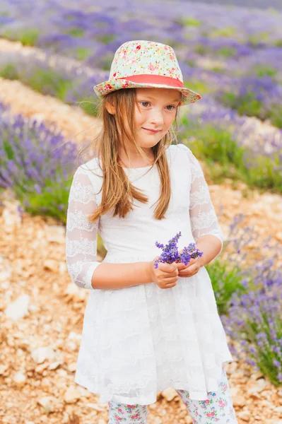 Adorable little girl playing in lavander field — Stock Photo, Image