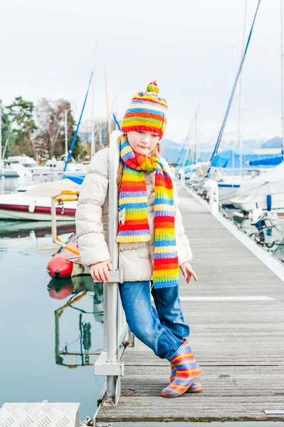 Outdoor Portret van een schattig klein meisje dragen jas en kleurrijke muts en sjaal — Stockfoto