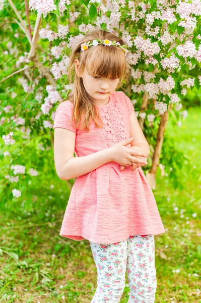 Outdoor portrait of a cute little girl on a nice sunny day, wearing coral dress and printed leggings — Stock Photo, Image