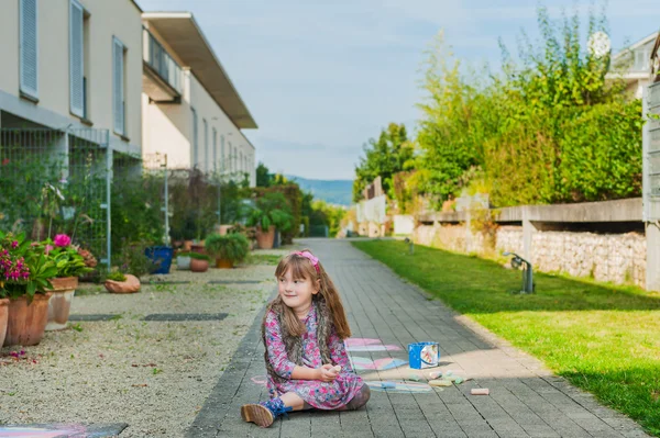 Niedliches kleines Mädchen, das in einem neuen Wohngebiet spielt, konzentriert sich auf ein Mädchen — Stockfoto