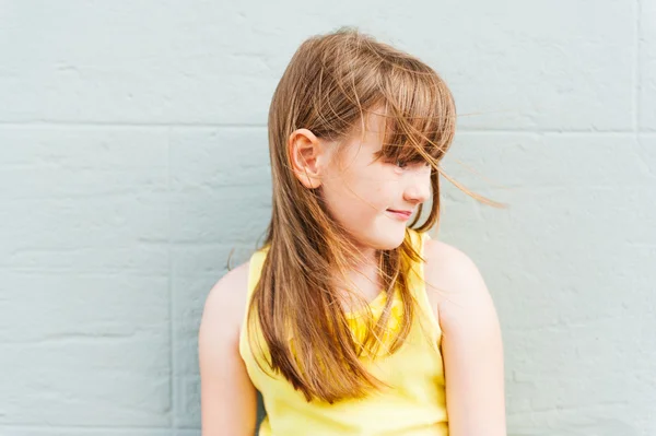 Outdoor portrait of a cute little girl, wearing yellow top — Stock Photo, Image