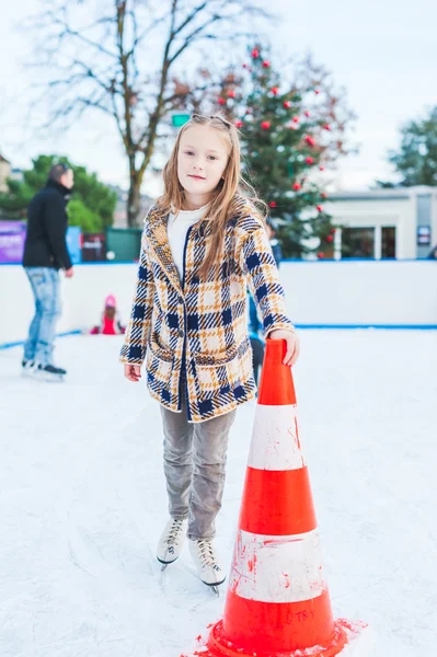 Linda niña aprendiendo a patinar con el apoyo en un buen día de invierno —  Fotos de Stock