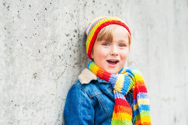 Outdoor portrait of adorable toddler boy wearing colorful hat and scarf — Stock Photo, Image