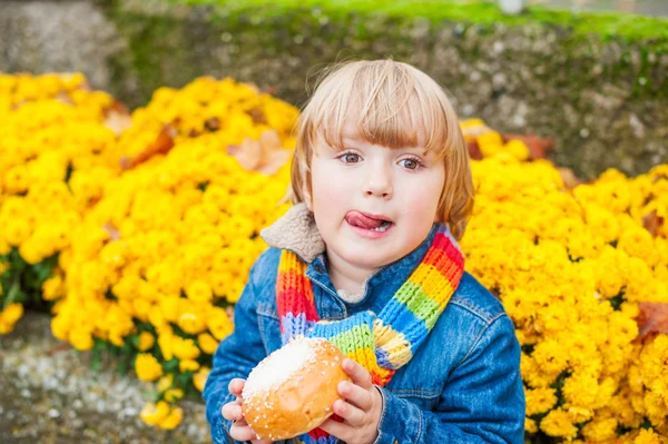 Outdoor portrait of adorable toddler boy wearing colorful scarf — Stock Photo, Image