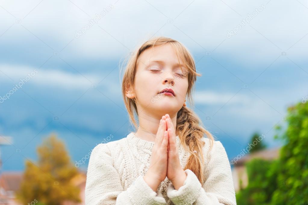 Cute little girl praying