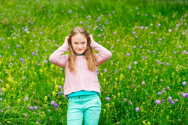 Menina bonito jogando em um parque, vestindo pulôver rosa — Fotografia de Stock