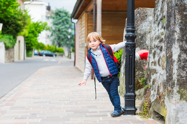 Young boy with backpack ready to go back to school